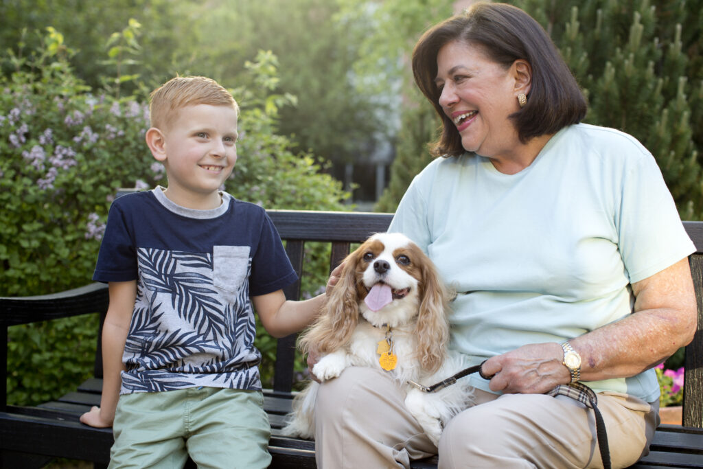 Senior woman with grandson and dog