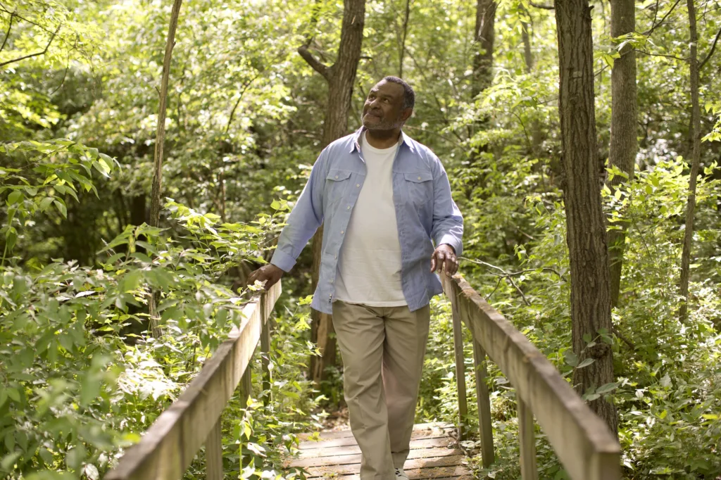 Senior man walking in nature trail
